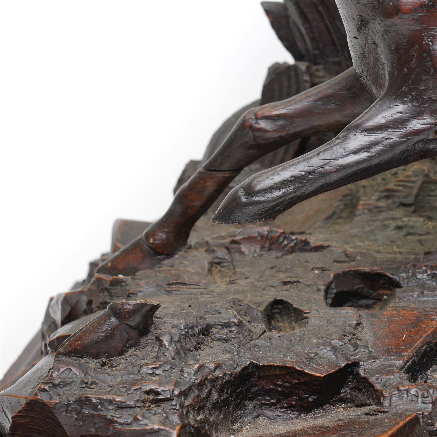 19th-century-8-day German Black Forest mantel clock c1880, with a carved oak case depicting a hunting scene with a stag pursued by hounds amidst rockwork and oak foliage, fitted with a French Parisian movement with a cast brass dial enclosed within a glazed brass bezel with a pendulum adjustment arbor, cartouche blue-on-white enamel  Roman numerals, engraved five minute Arabic's and contrasting steel Fleur-di-Lis hands, twin train going barrel movement with a recoil anchor escapement and countwheel strike. With pendulum.  