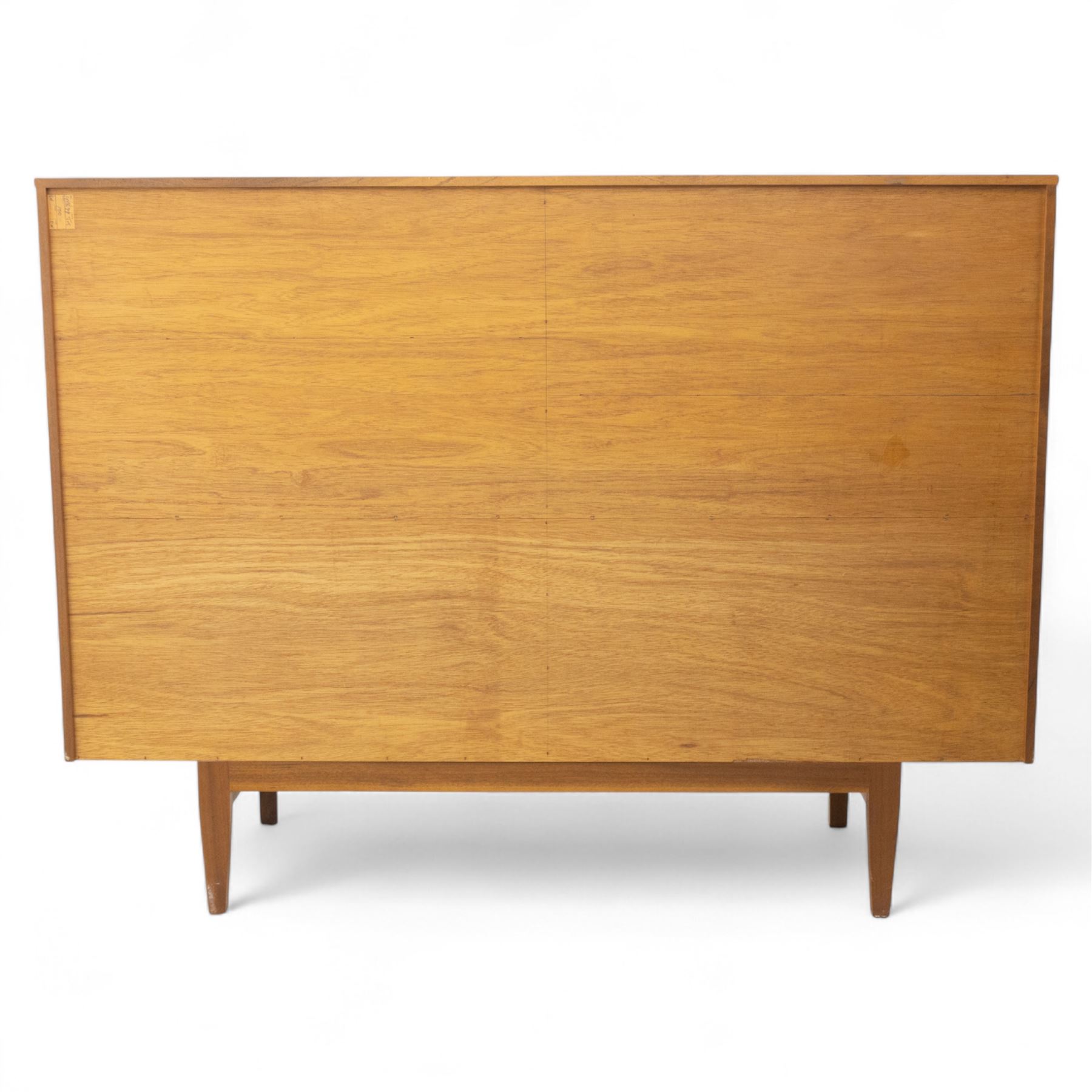 Sutcliffe of Todmorden - Mid 20th century teak highboard, ‘S-Form’ range, the upper section with glazed and panelled sliding doors above open shelving, over a base fitted with twin drawers and cupboards, all with moulded recessed handles, on shaped tapering supports, reflecting the sleek organic styling characteristic of 1960s British modern furniture design