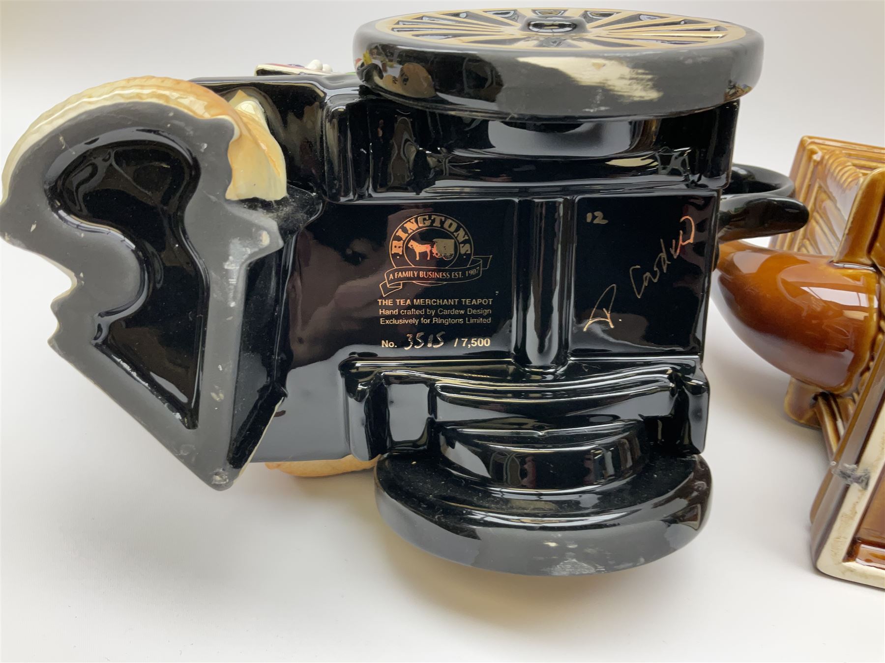 Three Ringtons novelty teapots, comprising The Ringtons Van teapot, the Tea Merchant teapot, and Millenium Celebration teapot. 