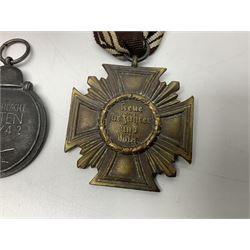 WW2 German Eastern Front Medal awarded to those who served on the German Eastern/Russian Front during the Winter Campaign period of 15th November 1941 to 15th April 1942 with original ribbon; German War Merit Cross with swords; and NSDAP Long Service Award (3)