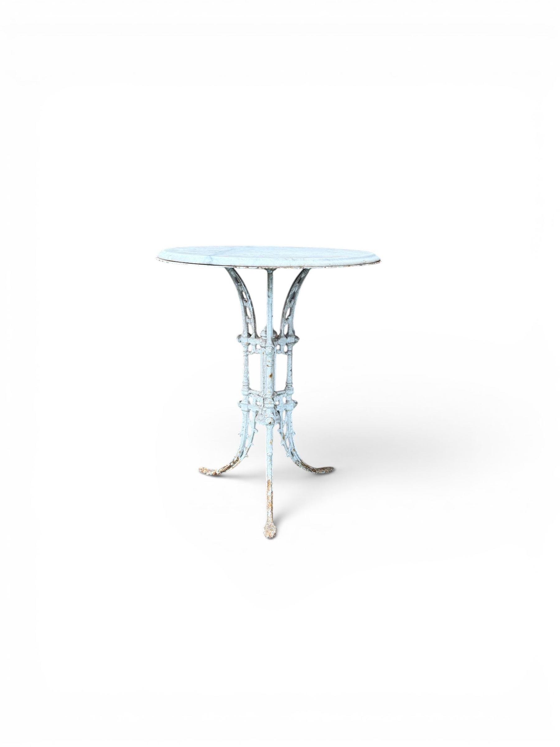 Victorian ornate cast iron garden table, trefoil base with central enclosed column, circular top with later marble, with registration mark