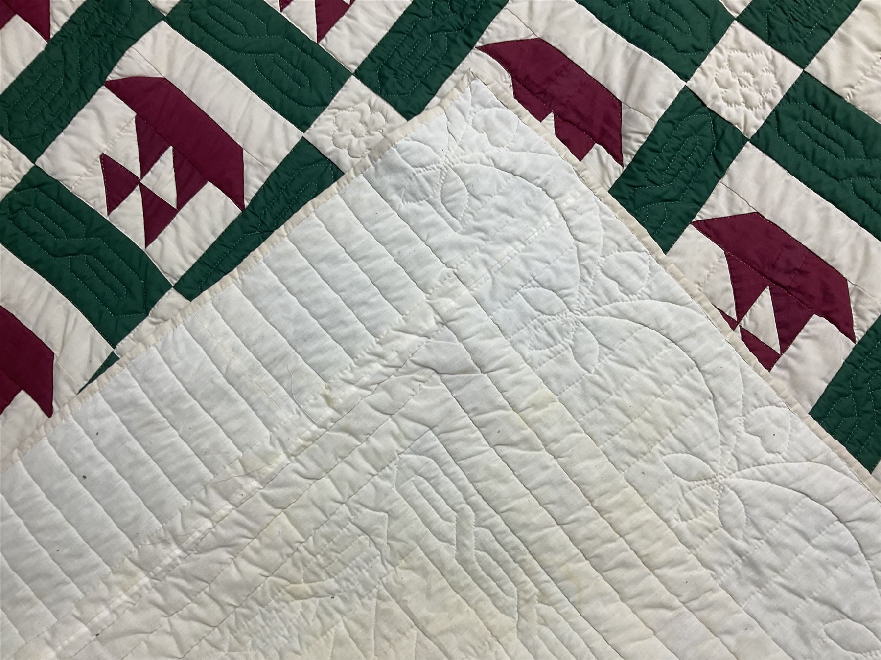 20th century quilt, with repetitive ship design to the centre within a cream red and green boarder, 227cm x 222cm