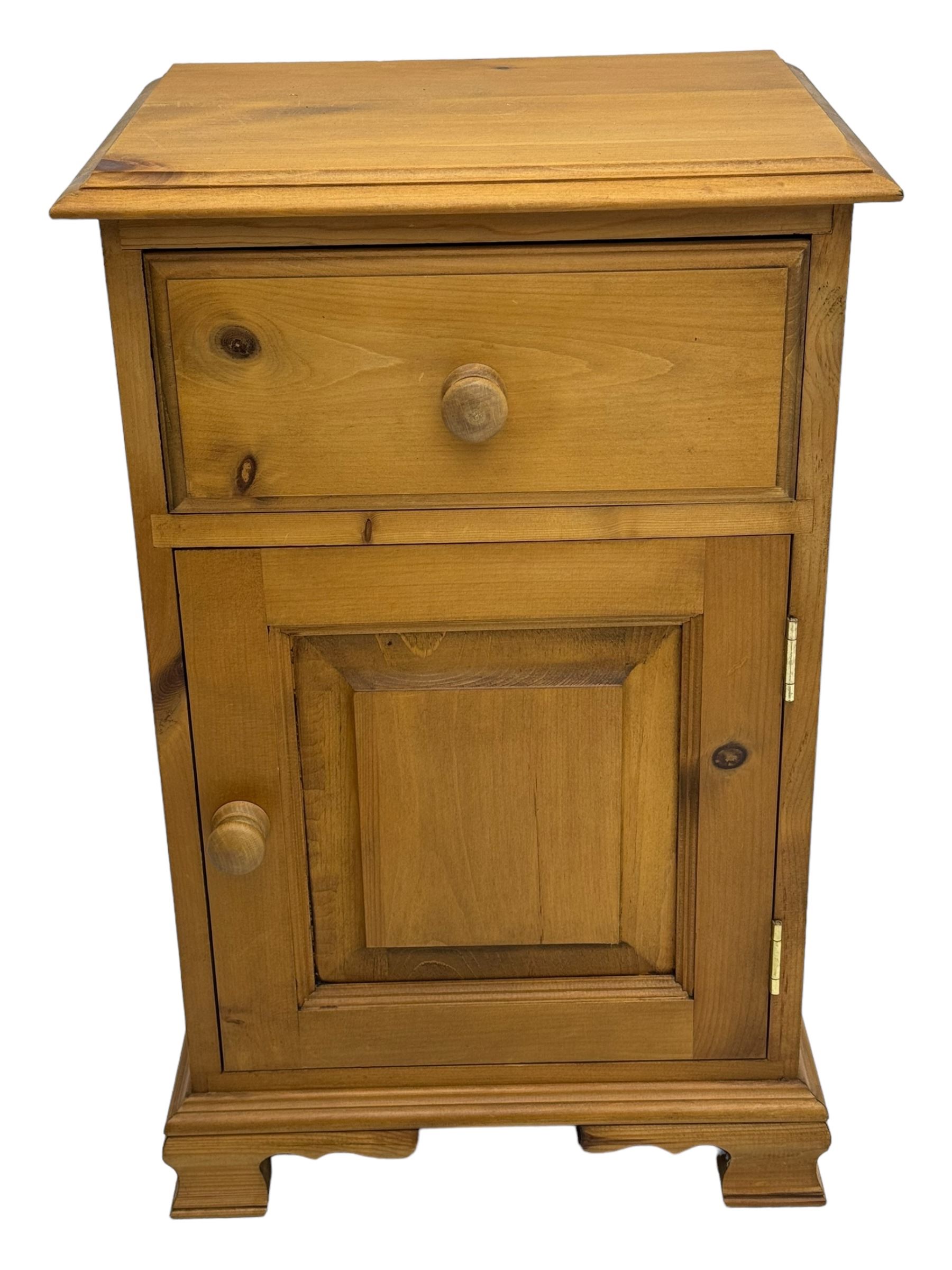 Pine chest of drawers topped with carved pediment with acorn and oak leaf motif, fitted with two short over three long drawers, standing on shaped apron base (W92, D46, H97cm); pine bedside cabinet, single drawer above paneled cupboard door enclosing open storage, shaped plinth base (W43, L32, H67cm)