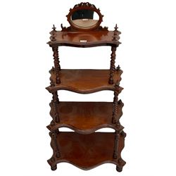 Victorian mahogany etagere, raised oval mirror in fretwork frame, four graduating shaped tiers, spiral turned supports