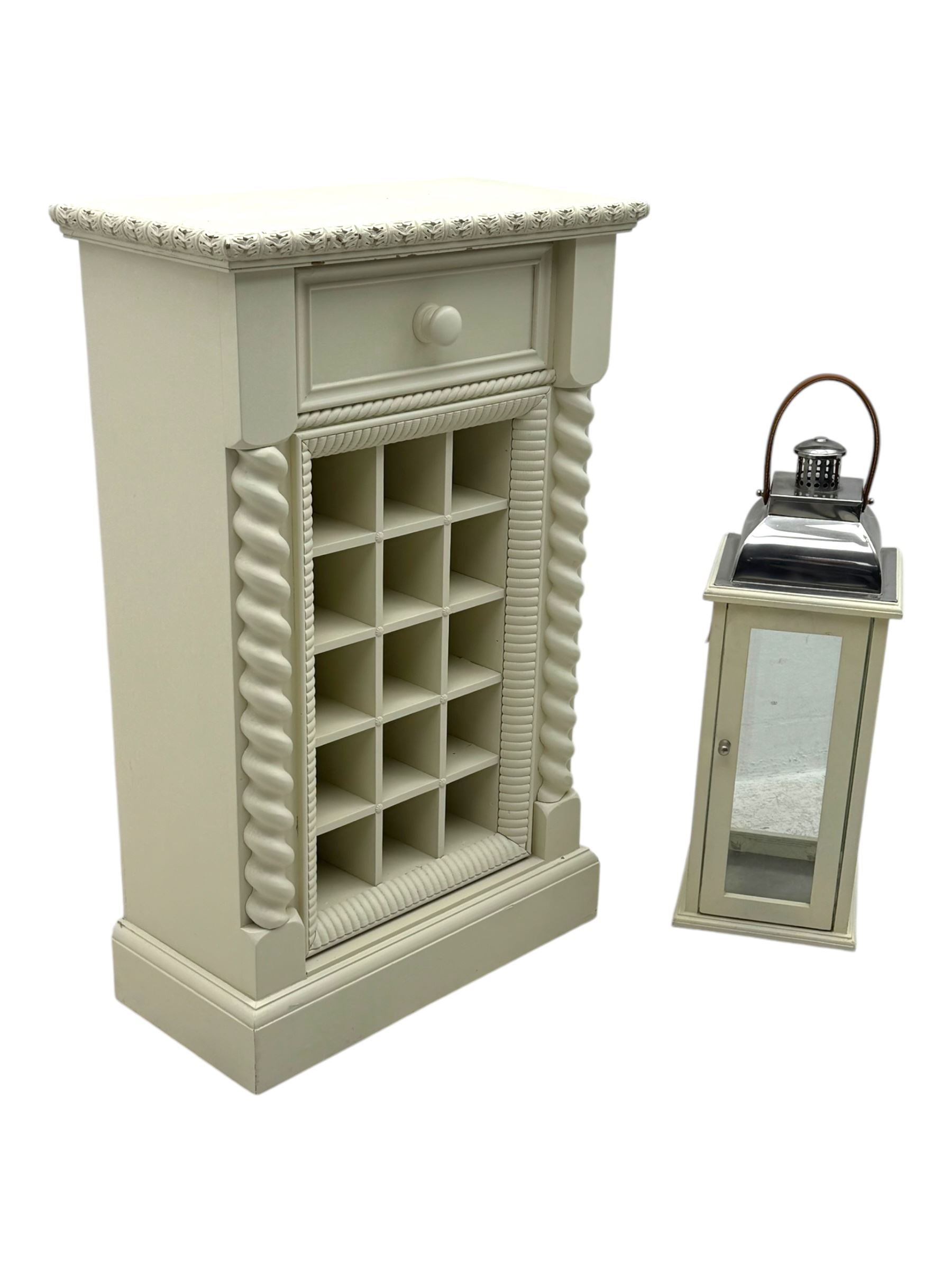 Contemporary painted wooden wine cabinet, rectangular form with carved leaf moulded cornice over single drawer and fifteen bottle compartments, flanked by spiral twist pilasters; together with a cream painted and chrome lantern, with glazed sides and leather handle (2)