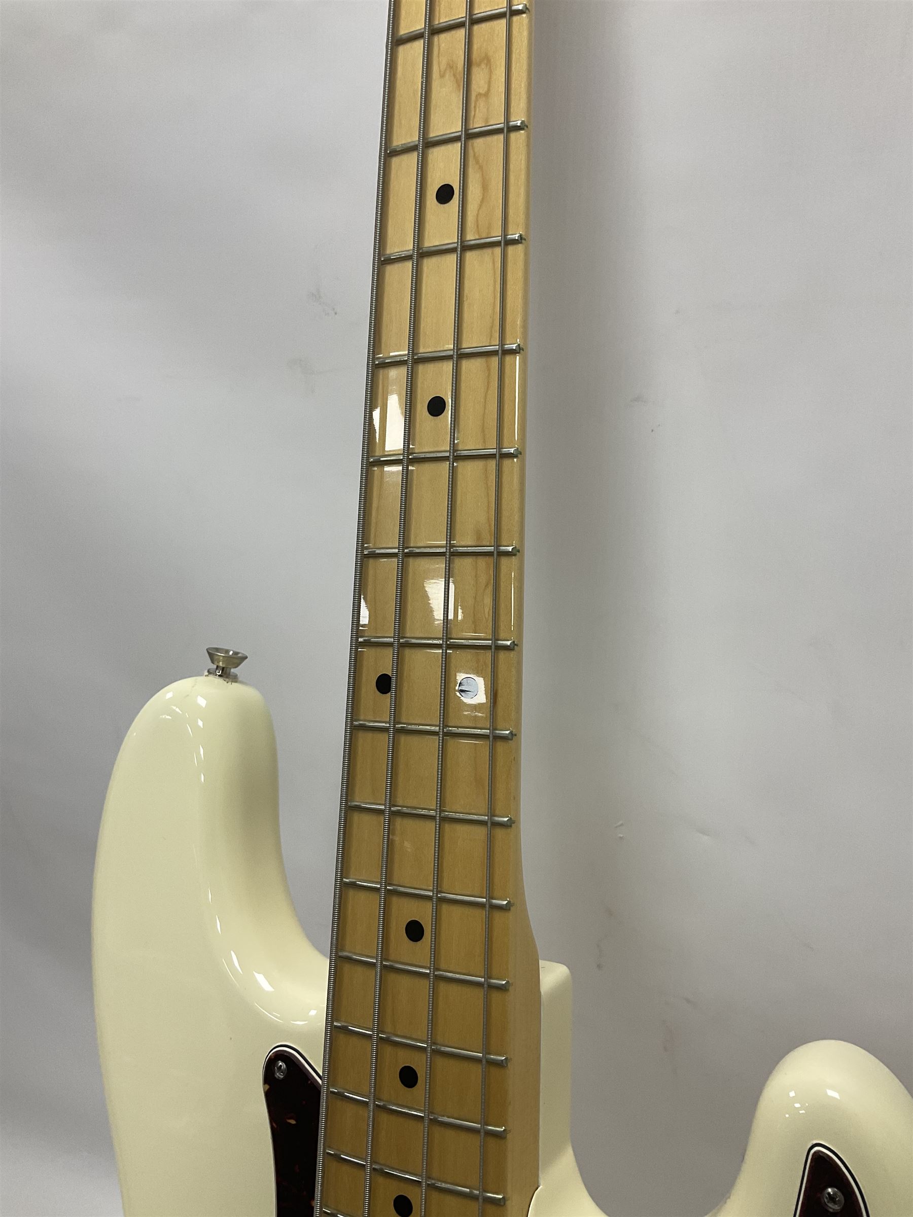 Fender Precision Bass guitar, in Olympic White finish with tortoiseshell effect scratchboard, serial no US15103092, in black Fender hard case with Fender strap and warranty card, guitar L116cm