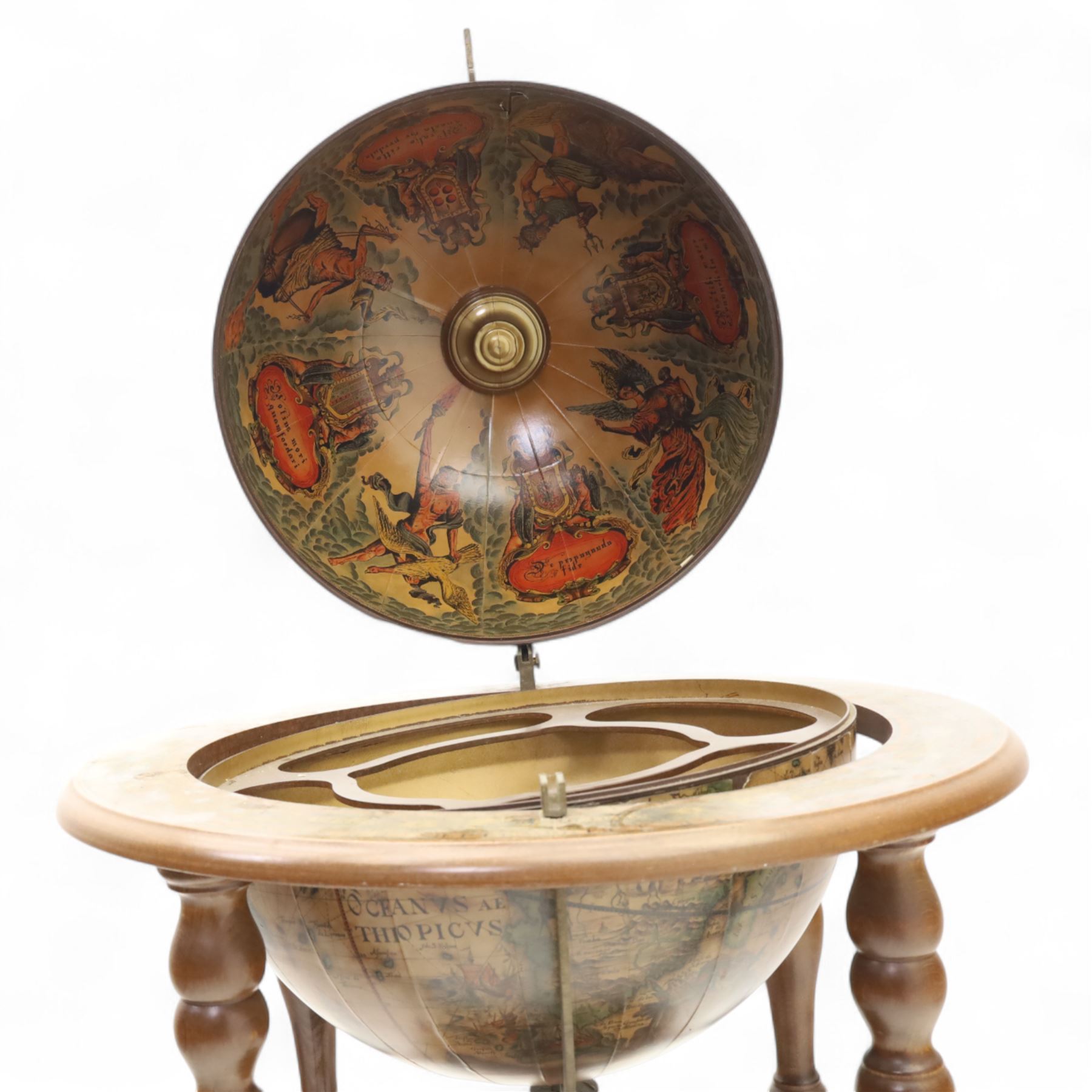 20th century Italian design drinks globe, the hinged celestial printed sphere enclosing a fitted bottle and glass compartment, circular base decorated with zodiac signs and mounted on turned supports with castors