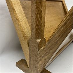 Mouseman - oak magazine rack, the top rail pierced with handle and carved with mouse signature, octagonal supports with two panelled and splayed sides, on sledge feet, by the workshop of Robert Thompson, Kilburn 
