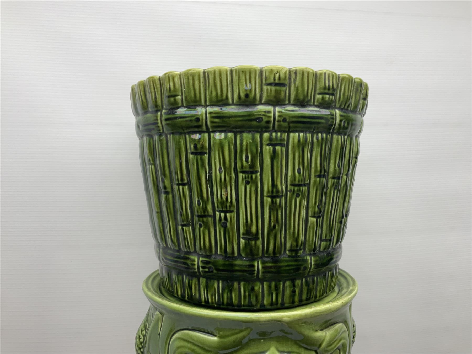 Jardiniere and stand, the jardiniere modelled as a pale, the stand with foliate and foliage decoration on a green ground, stand H73cm 