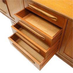 G-Plan - 'Fresco Long John' teak mid 20th century sideboard, a central bank of four drawers, flanked by twin cupboard doors, with recessed handles, on a tapering supports 