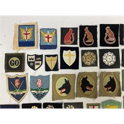 Approximately one-hundred printed and embroidered cloth badges including Royal Tank Regiment, Royal Armoured Corps, 219th Independent Infantry Brigade, Cyrenaica, Cyprus, Singapore and other districts, Gibraltar Garrison, East Anglian Brigade, 20th Armoured Brigade and various armoured divisions etc