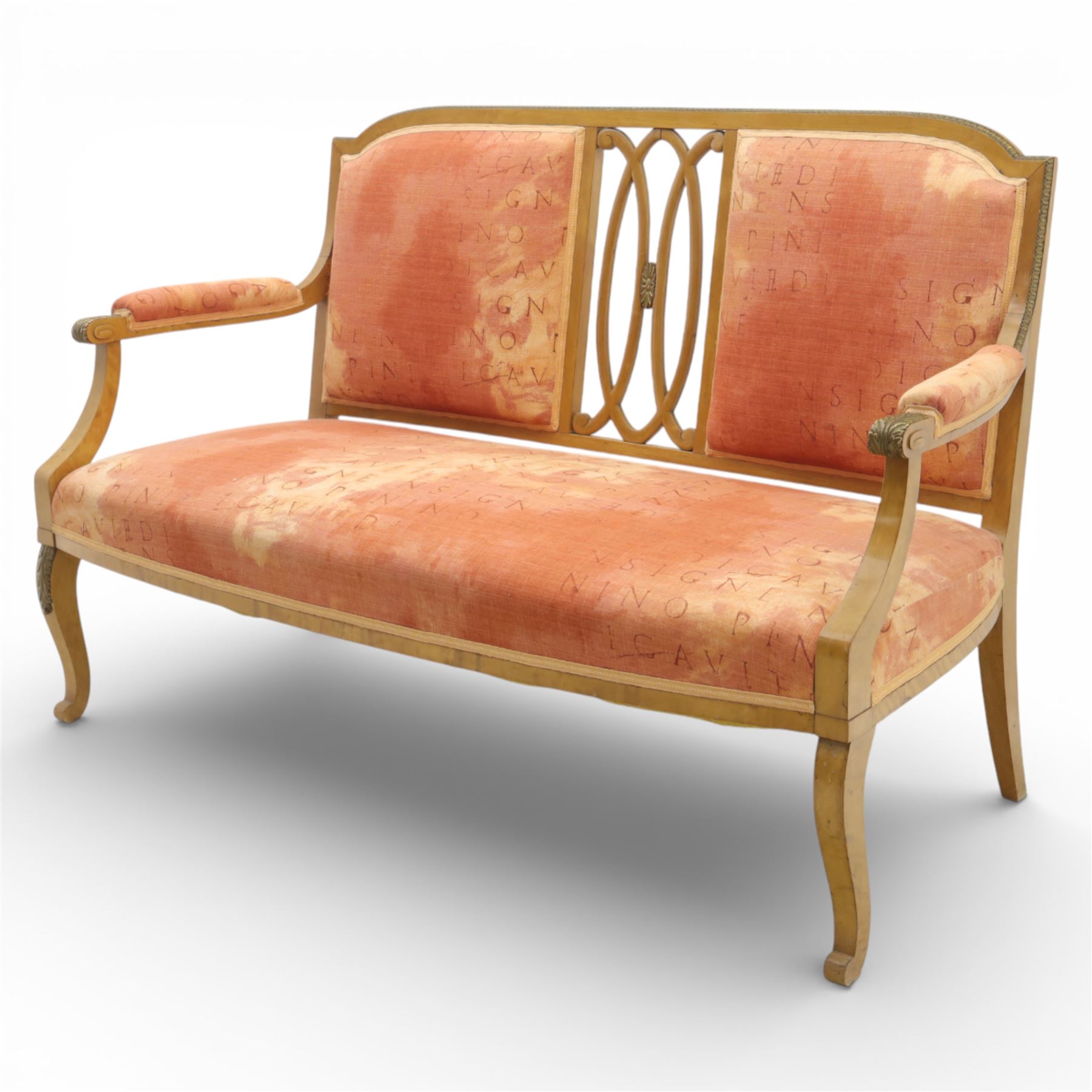 Edwardian satinwood settee, the shaped and bowed top rail enclosing a pierced splat with interlaced oval slats, flanked by upholstered back panels, the padded arms with scrolling terminals, the upholstered seat raised on cabriole supports with pad feet