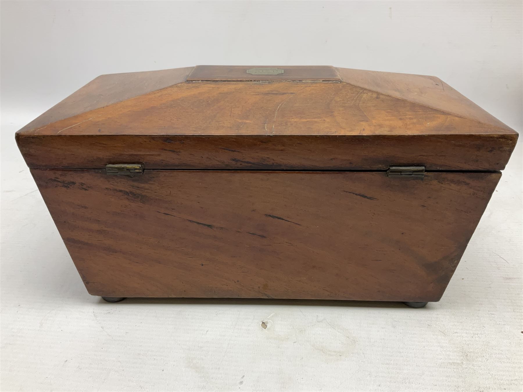 Walnut tea caddy of sarcophagus form, two division lidded interior with a later glass mixing bowl, upon four brass bun feet together with a walnut sewing box with mother of pearl inlaid decoration, tea caddy H16cm
