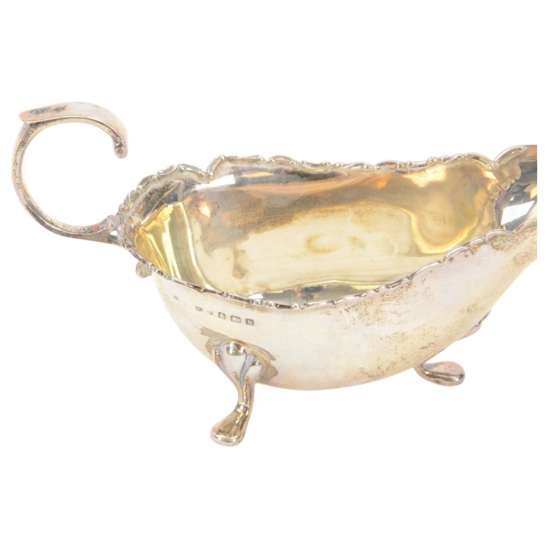 Edwardian silver sauce boat, of typical plain form with shaped rim, with flying C scroll handle and upon three pad feet, hallmarked Birmingham 1907, maker's mark worn and indistinct, together with a pair of Edwardian silver cruets, of urn form, upon three pad feet, hallmarked Horace Woodward & Co Ltd, Birmingham 1905 and a set of six silver apostle spoons, with matching sugar tongs and sugar sifting spoons, some hallmarked Miller Bros, London 1895 and Charles Boynton, all contained within fitted cases