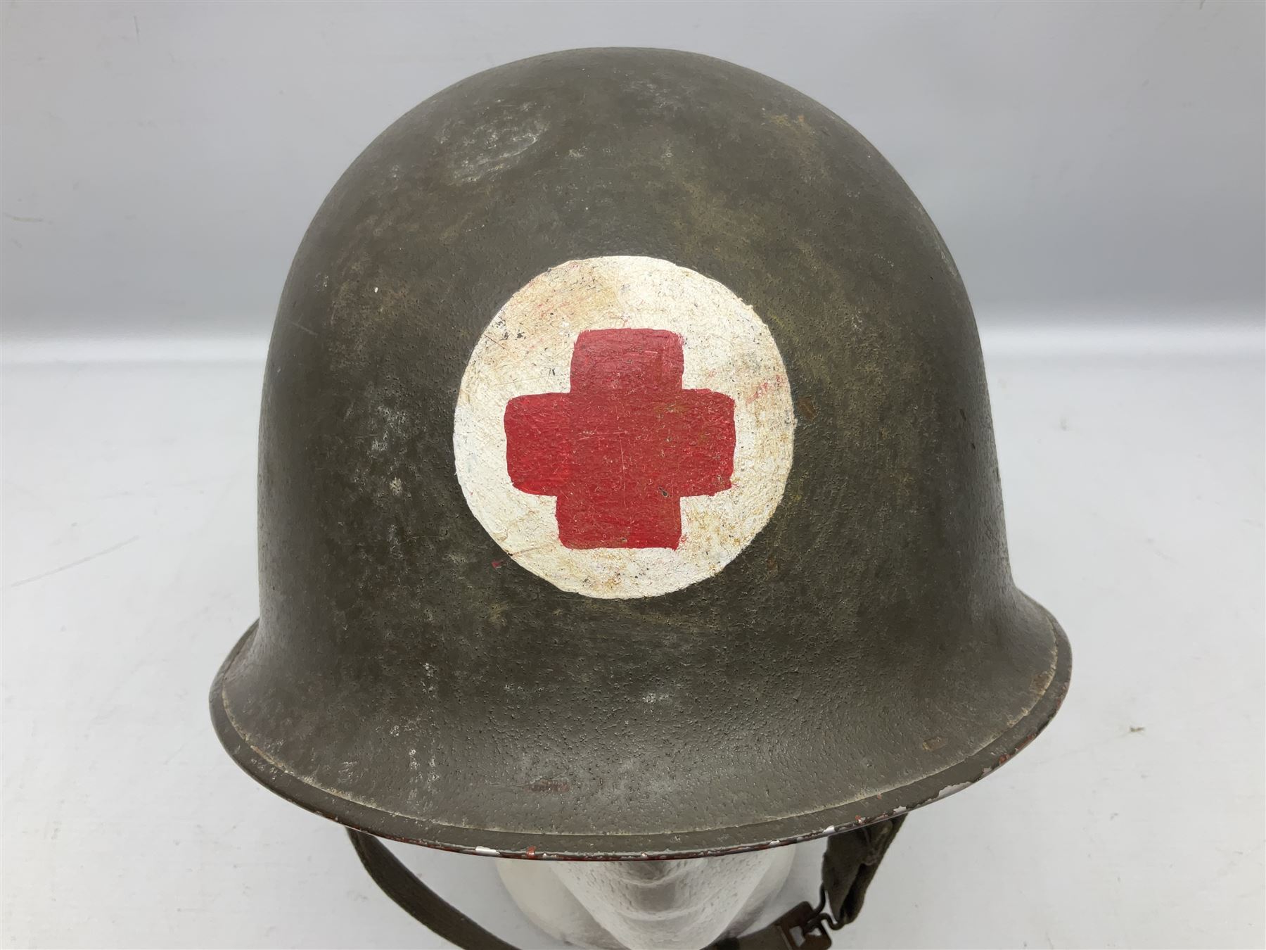 French Algerian War Red Cross steel helmet, marked 'CP ICA Esperaza 1955'; green finish with crudely painted Red Cross logo to the front