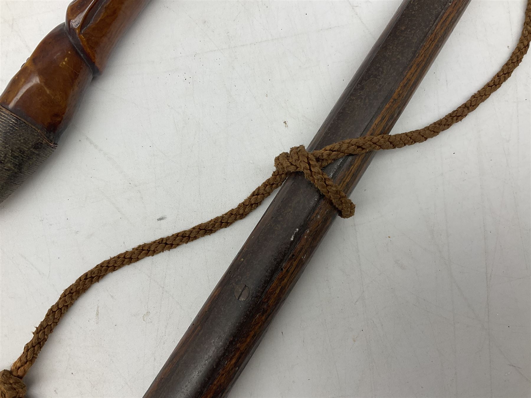 Tribal Art - an African axe, possibly Yoruba, the bone shaft carved as two cord bound stylised figures with iron fan-shaped blade, L35cm overall; and 19th century harpoon or spear head of square section with two long fixing arms on cut-down ash shaft L57cm (2)