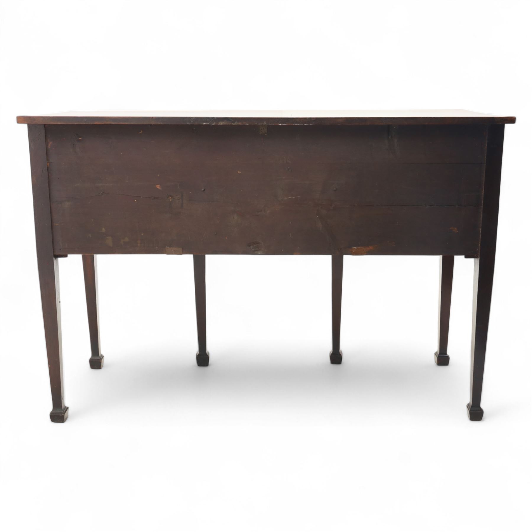 George III Sheraton-style mahogany sideboard, serpentine front fitted with central drawer and flanked by two deep drawers, raised on square tapered legs with spade feet 