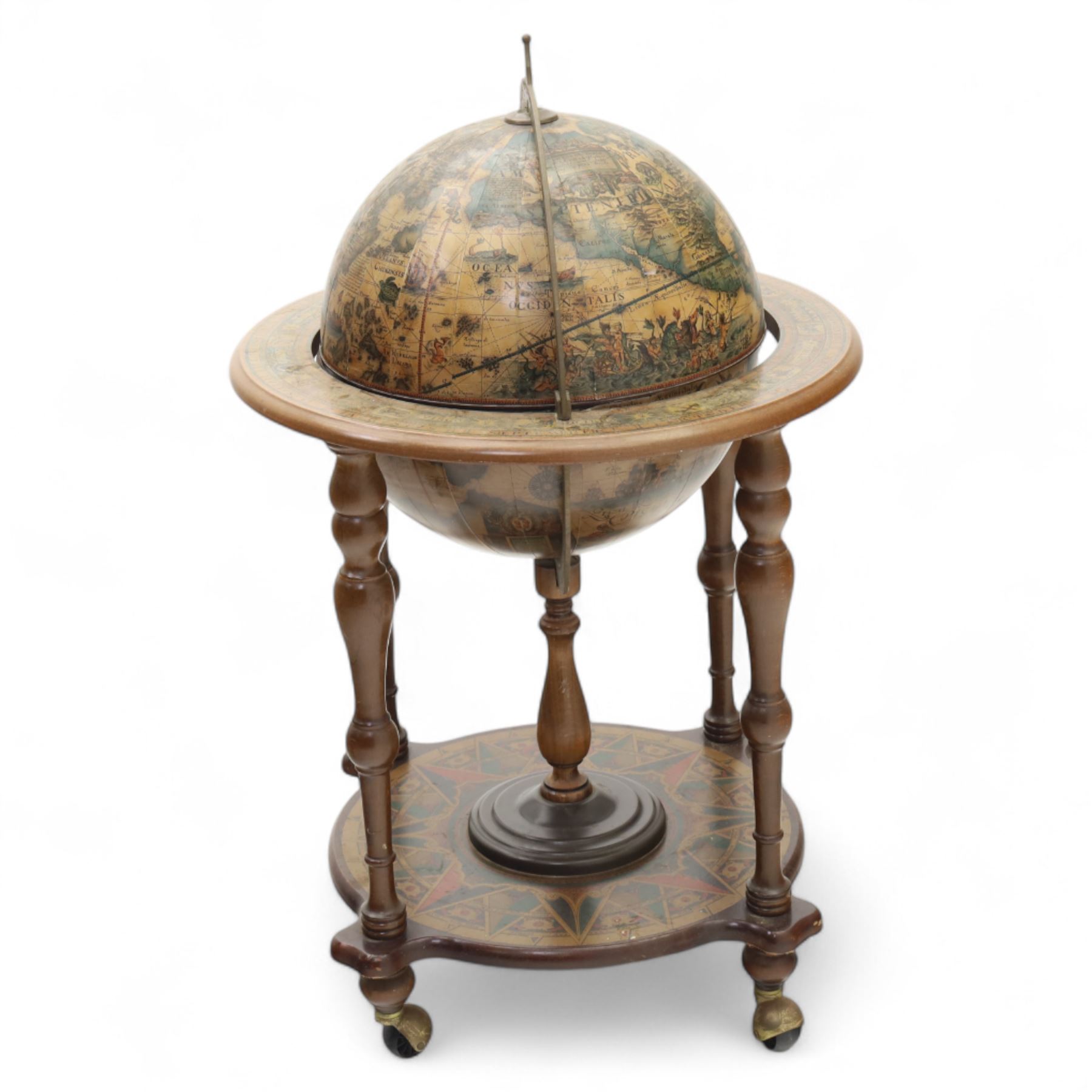20th century Italian design drinks globe, the hinged celestial printed sphere enclosing a fitted bottle and glass compartment, circular base decorated with zodiac signs and mounted on turned supports with castors