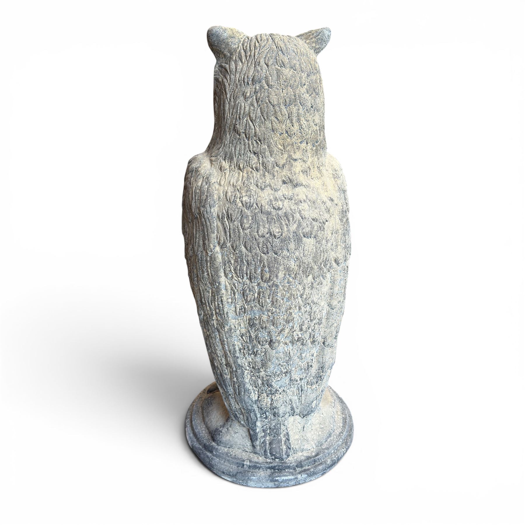 Pair of large composite stone garden statues modelled as standing horned owls, raised on circular bases