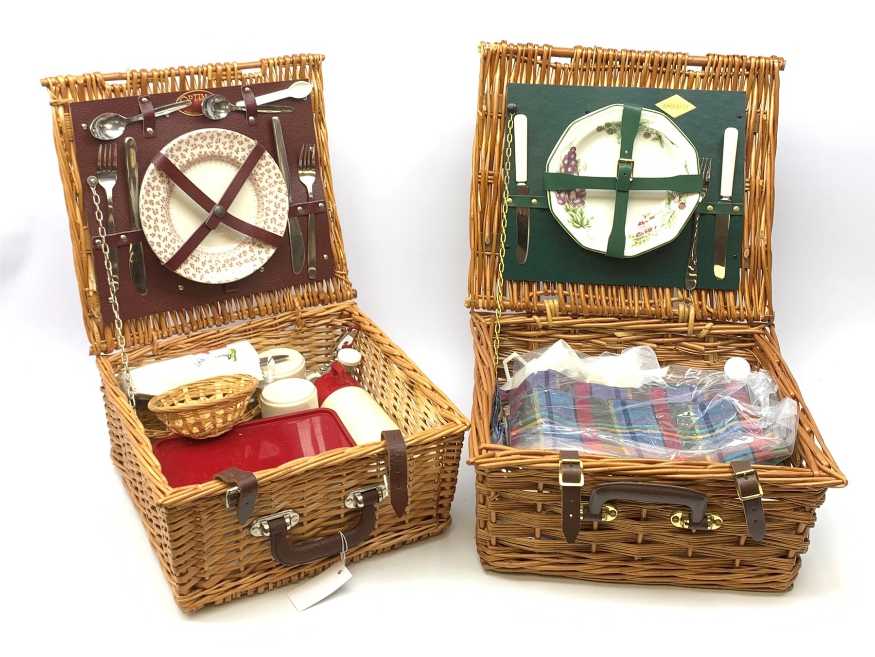 A wicker Amberley picnic basket, together with a wicker Optima example, each with contents. (2). 