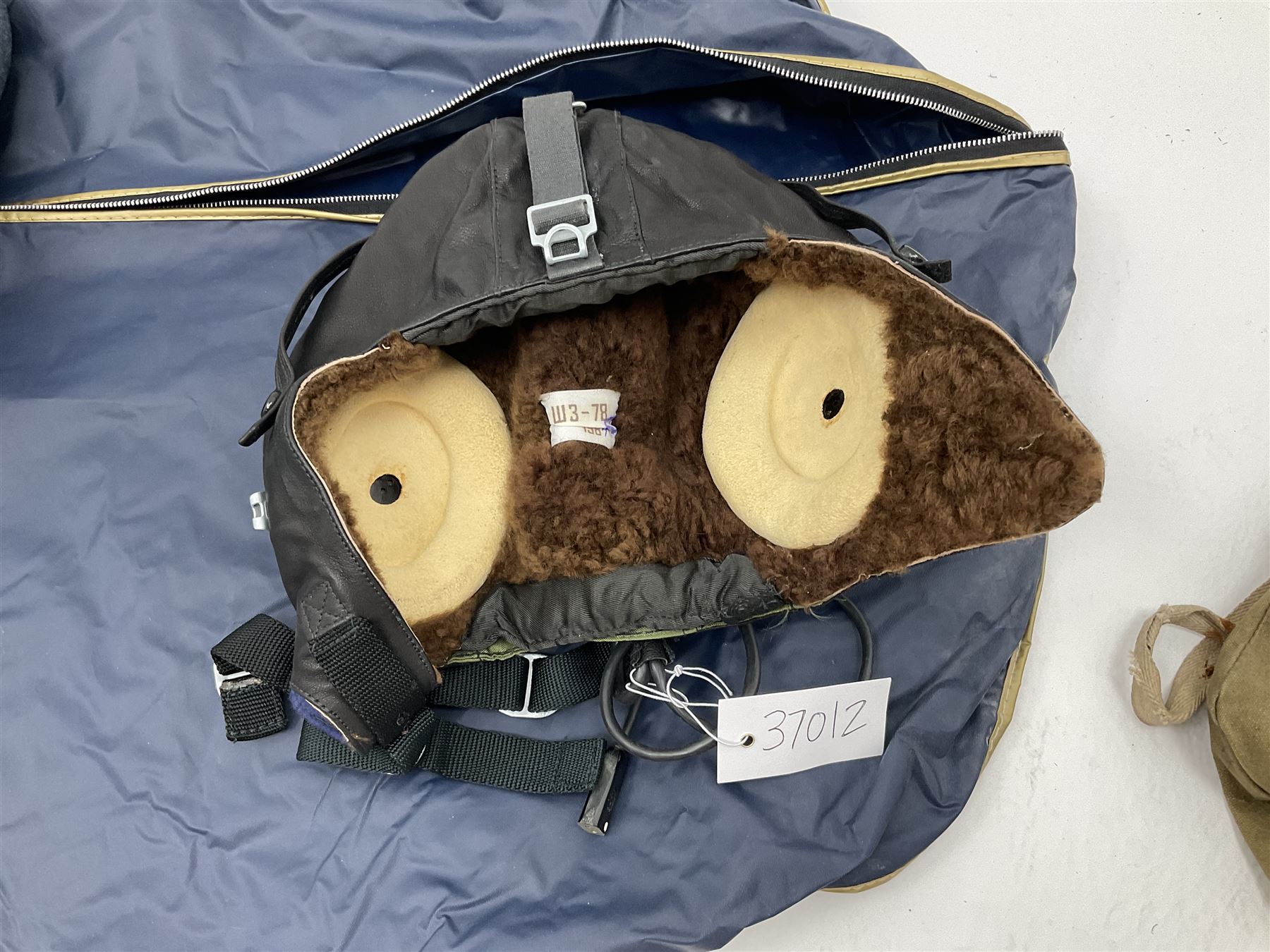 RAF Flight Lieutenant's uniform with peaked cap and WW2 ribbon bar; WW2 gas mask in blue canvas bag dated 1942; flying helmet date 1984; and British Army Major's uniform with Staybrite buttons and peaked cap