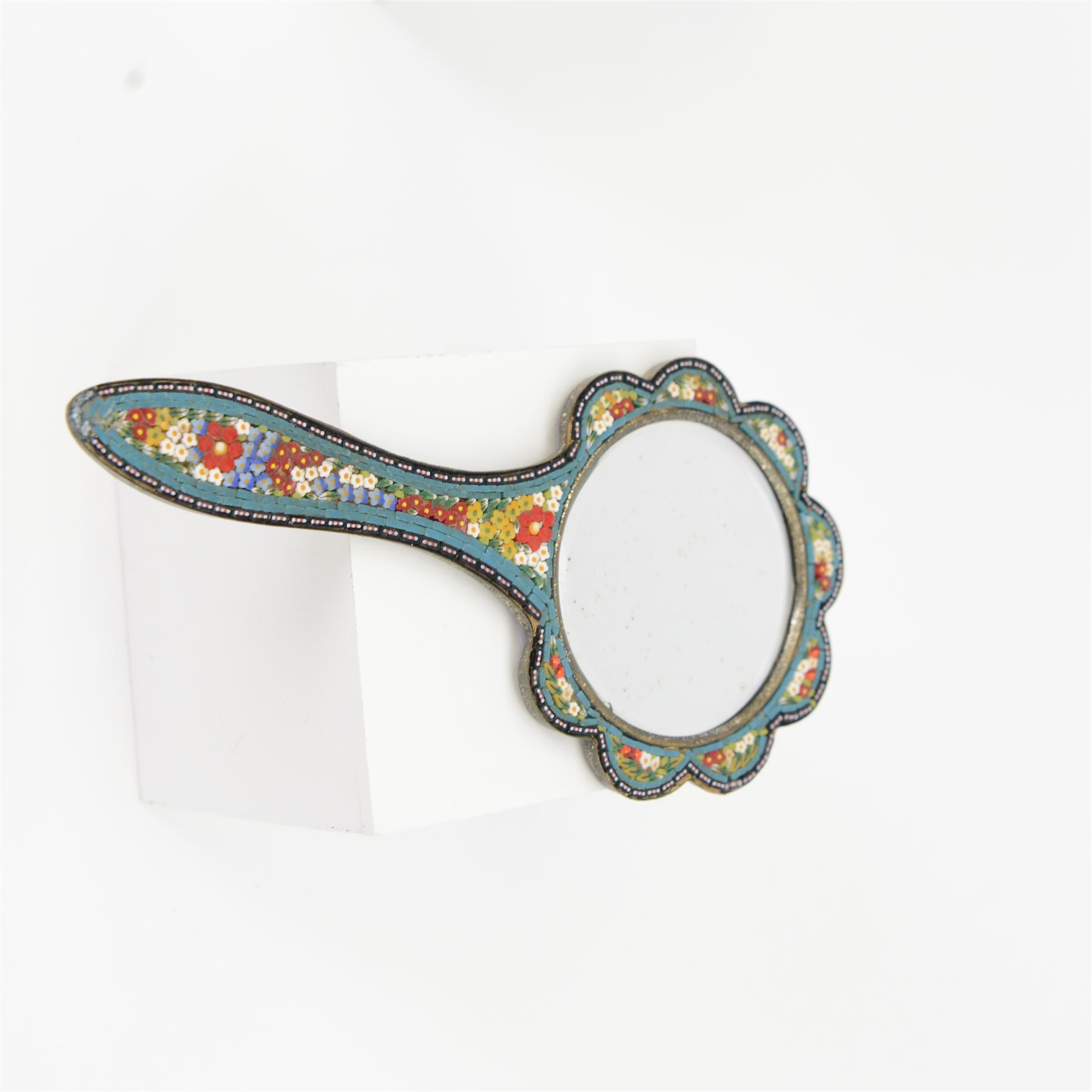 Venetian micro mosaic framed hand mirror, the bevelled oval plate surrounded by colourful flowers against a cream ground, together with another, largest H23cm 