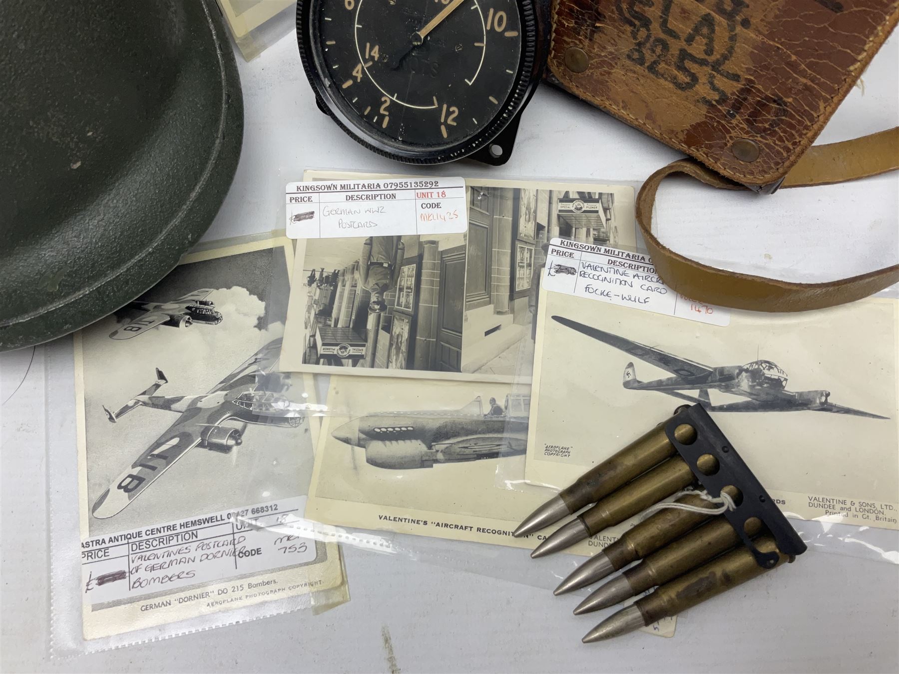 Bakelite cased Megger Insulation tester, by Evershed and Vignoles Ltd, Acton Lane Works, Chiswick, London W4, RW Munro Ltd air speed knots gauge, American green army helmet, The War Illustrated, WW2 aircraft photographic postcards, etc
