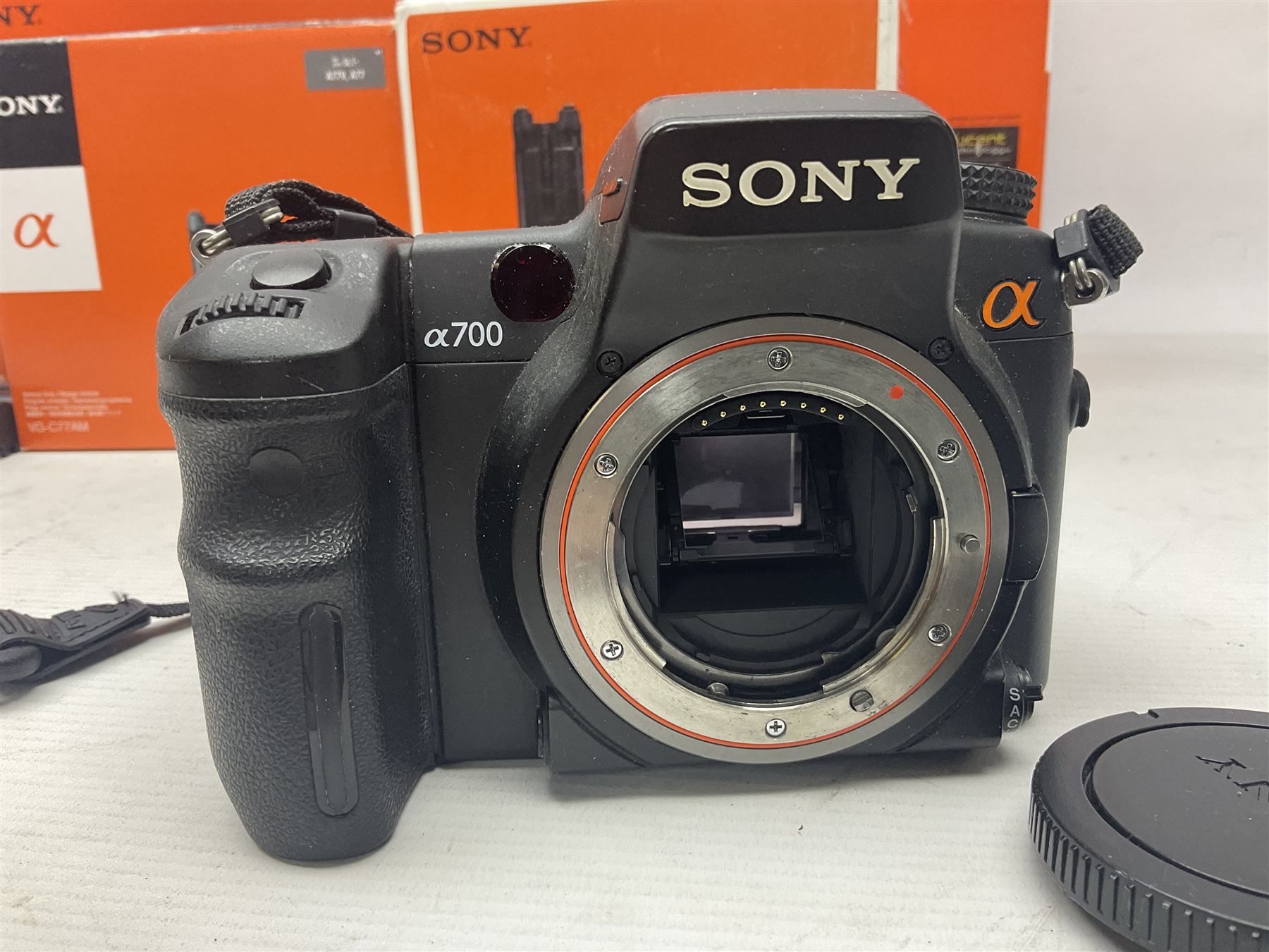 Sony Alpha A700 camera body, serial no 2340937, Sony Alpha A77 camera body, serial no 0715406, together with Sony angle finder and two firm holding grips, all with original boxes  