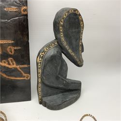 Collection of traditional necklaces from the Solomon Islands, including shell and boar tusk examples, together with a carved canoe prow, with mother of pearl eyes, painted cow hide and a copper plaque, depicting the Solomon Islands, with presentation engraving