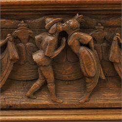 Carved oak coffer bench, rectangular moulded top above carved fall front, with figural, mask and foliate decoration, panelled sides, raised on turned bun feet with shaped lower apron