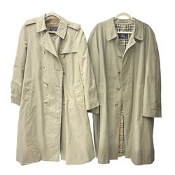 Ladies Burberry double breasted trench coat, with belt and detachable woollen gilet, in traditional cream colour with Burberry check lining, together with a gentlemans Burberry single breasted trench coat, both L112cm