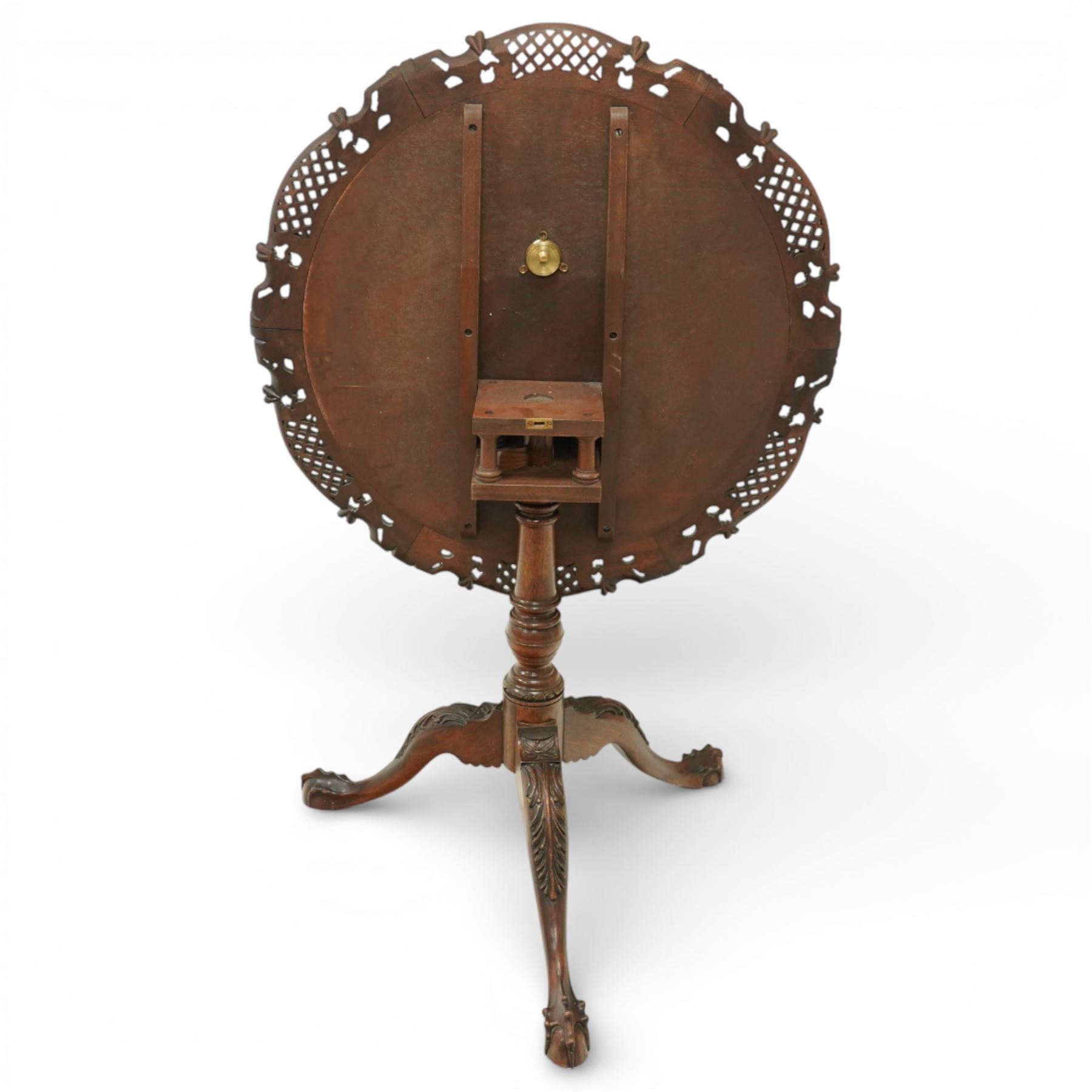 Late 19th century Rococo Revival mahogany occasional table, with shaped circular top with ornate lattice-pierced edge, decorated with pierced scallop motifs and acanthi, raised on a birdcage movement over turned pedestal, terminating to foliate-moulded tripod base with ball and claw feet