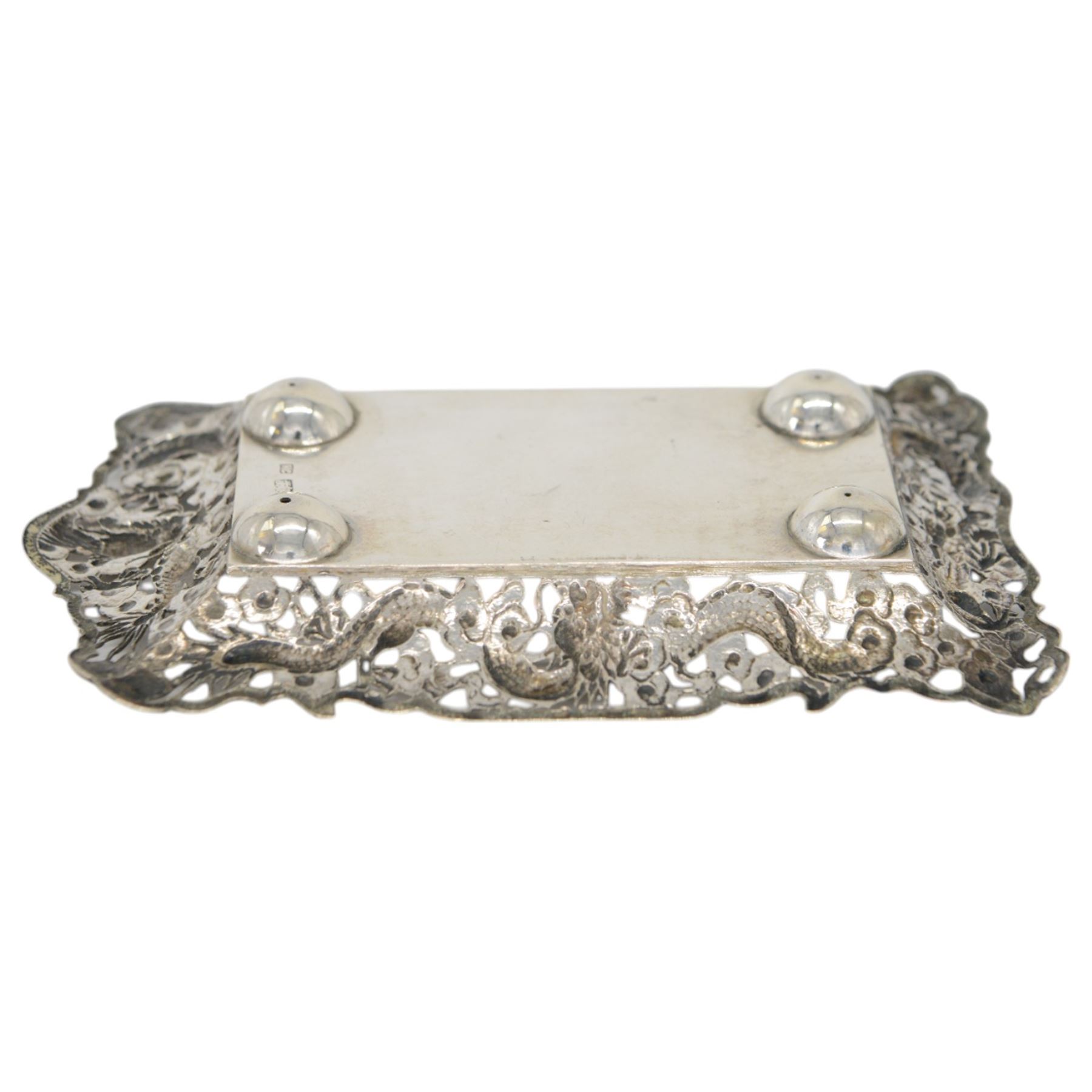 Chinese export pin tray, of rectangular form, the pierced sides embossed with dragons amongst flowers, stamped with character marks and maker's mark for Hungchong & Co, L13cm 