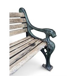 Neoclassical design cast iron and oak slatted garden bench, the twin end supports in the form of a Sphinx with acanthus carved knees and large paw feet, the pierced lattice bracket with Yorkshire rose motifs