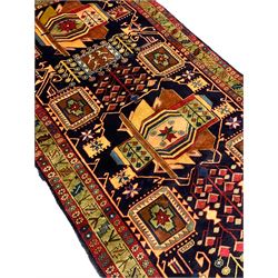 North West Persian Heriz Kelleh rug, the blue ground field with large stylised plant medallions, decorated with flower head, bird and tree of life motifs, triple band foliate pattern borders 