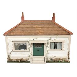 Scratch-built wooden dolls house as a double fronted single storey bungalow with stucco walls and windows to the front and back; the lift-off hipped roof with simulated tiling, giving access to three fully furnished rooms complete with a large quantity of accessories W64cm H48cm D46cm