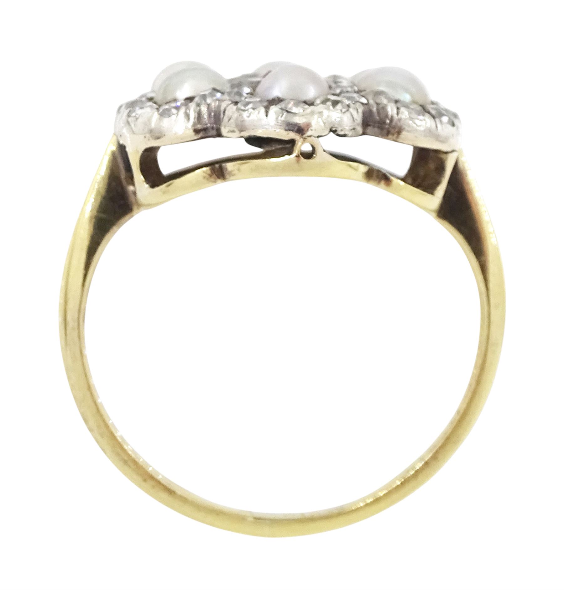 Early 20th century 18ct gold and silver ruby, diamond and pearl flower head cluster ring, single octagonal cut ruby of approx 0.30 carat, with old cut and rose cut diamond and split pearl surround