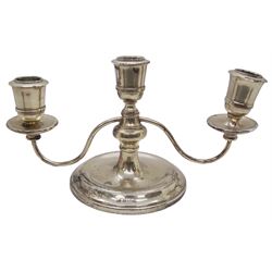 Modern silver twin branch squat candelabra, with filled circular stepped base leading to a short knopped stem supporting a central capital, and twin curved branches leading to conforming capitals above drip pans, hallmarked Birmingham 1972, makers mark partly worn and indistinct, H12.5cm 