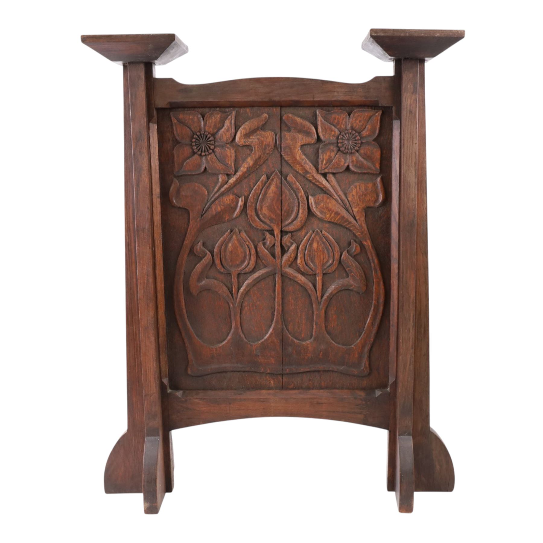 Art and Crafts carved  oak firescreen, the rectangular panel carved with Art Nouveau flowers and foliage, H84cm