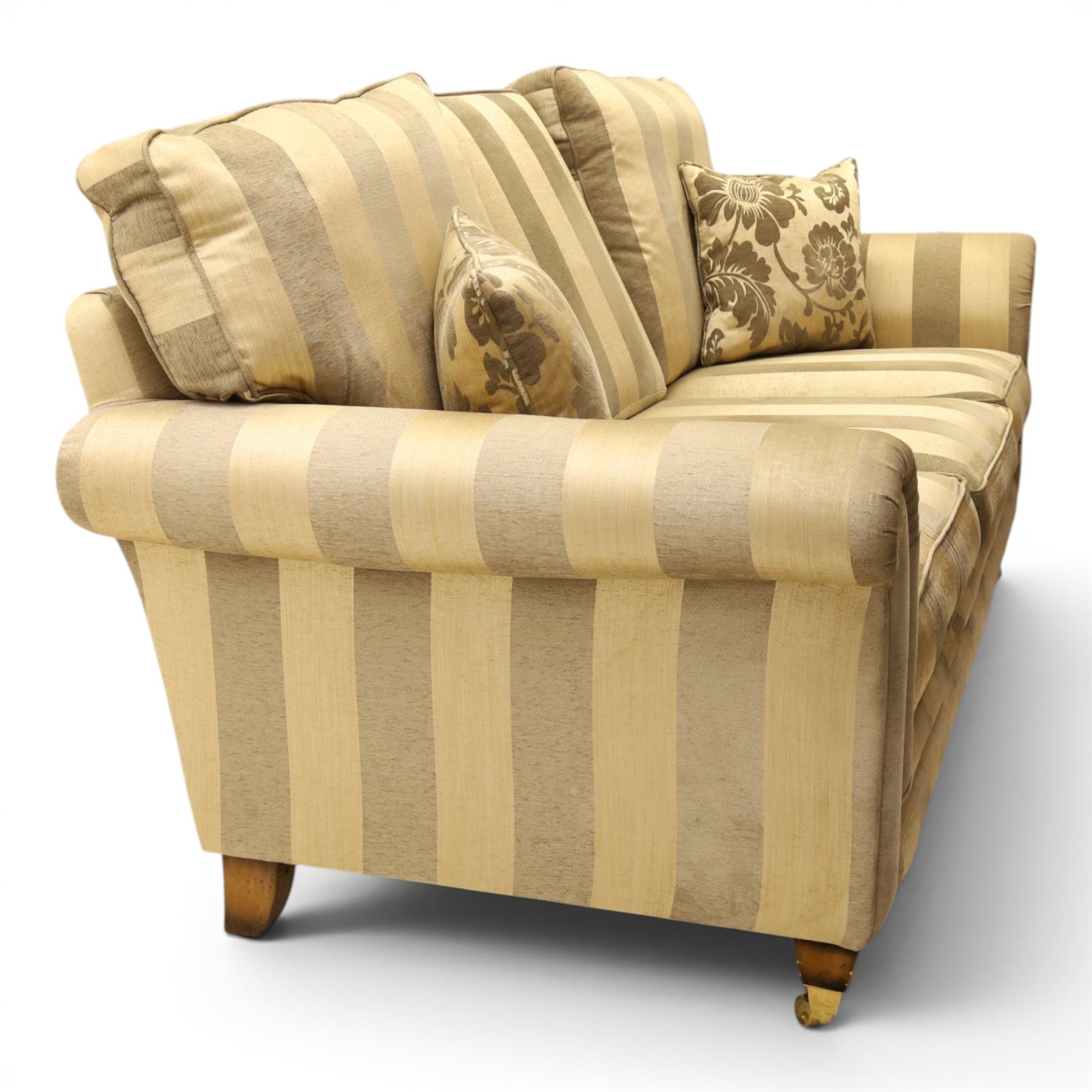 Alstons - 'Ixworth' three seat sofa, upholstered in striped fabric, with loose seat cushions and scrolled arms, front brass castors