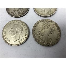Four silver World coins comprising Queen Victoria 1889 crown, King George VI 1937 crown, Marie Thaler 1780 restrike, and mounted United States of America 1928 peace dollar 