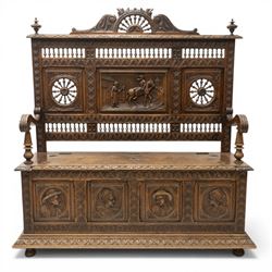19th century European heavily carved oak hall settle, the impressive high-back with a pier...