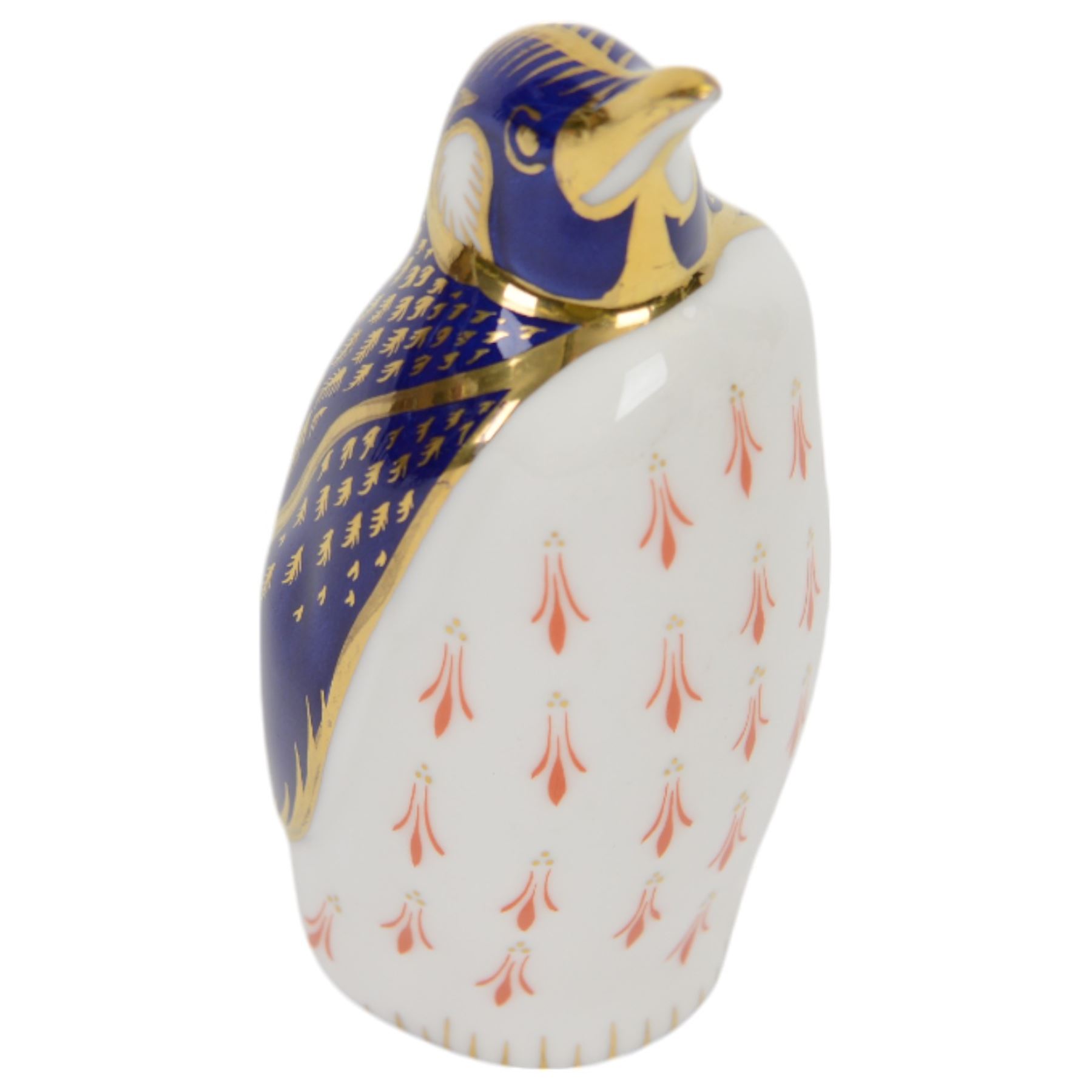 Four Royal Crown Derby paperweights, comprising Large Ram with gold stopper, Penguin with gold stopper, The Spaniel with gold stopper and box and Contented Cat with gold stopper and box   