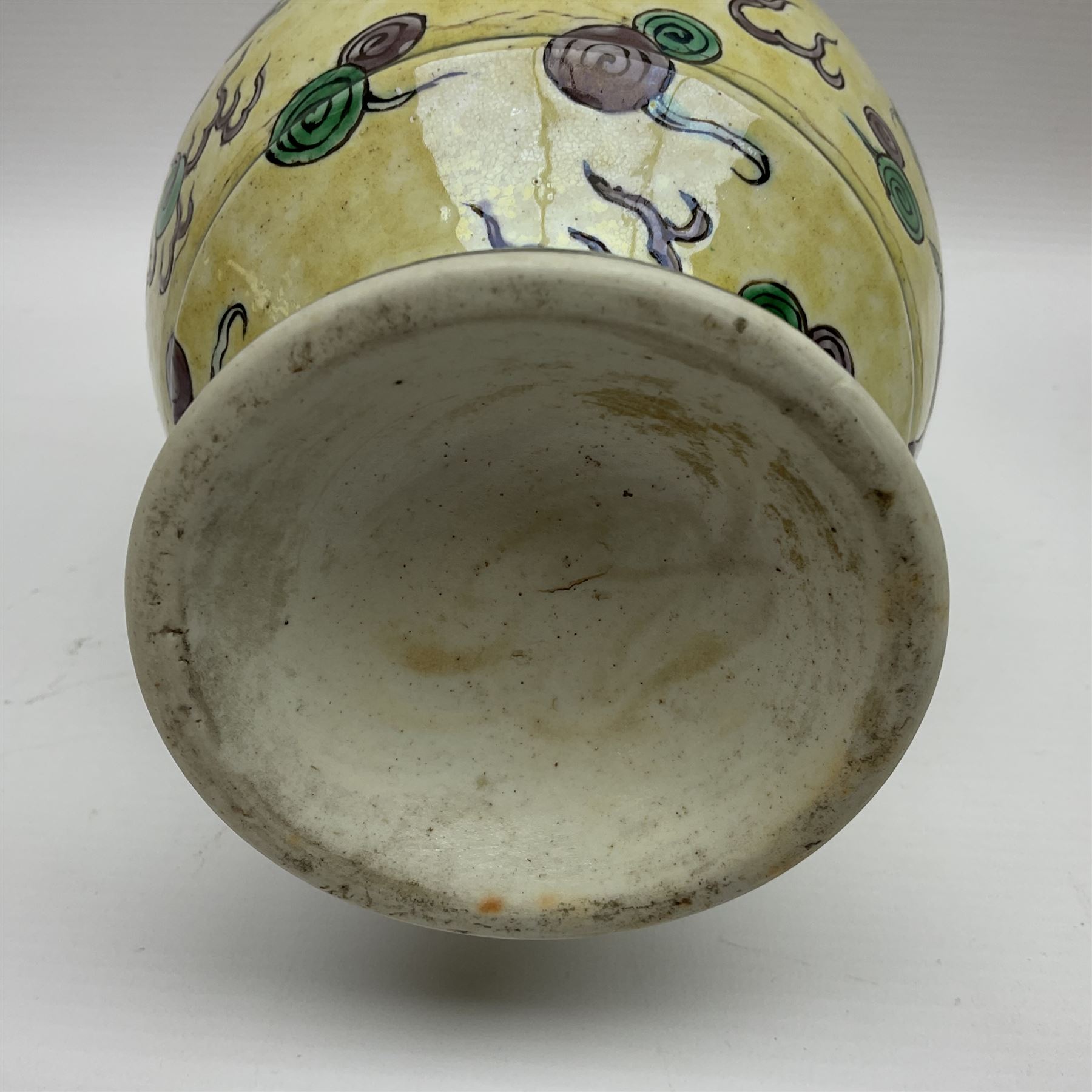 20th century Chinese Famille Verte vase, of slender ovoid form with tapering neck and flared rim, decorated with green and grey enamel with dragons chasing flaming pearls amongst auspicious clouds upon a yellow ground, H30cm