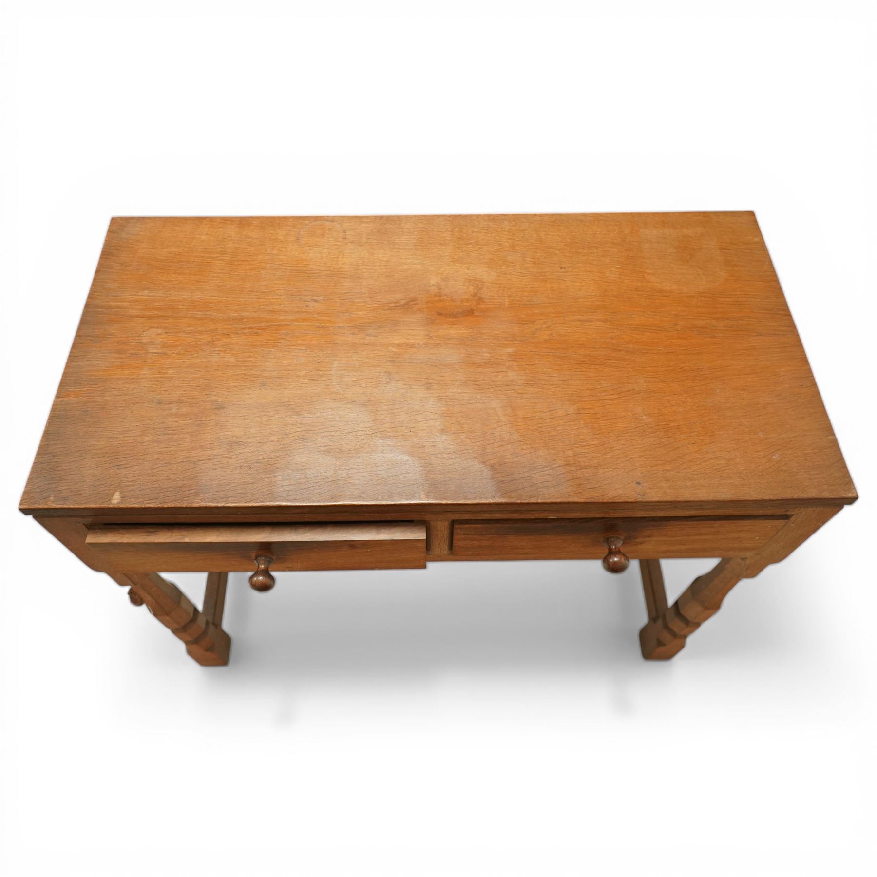 Mouseman - oak side table, rectangular adzed top, fitted with two drawers with turned wooden knobs, raised on octagonal supports, with carved mouse  signature, by the workshop of Robert Thompson of Kilburn