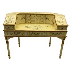 Oriental Carlton House style cream lacquered desk, decorated with floral motifs, fitted with eleven drawers and two cupboard doors, raised on turned legs with carved floral motifs