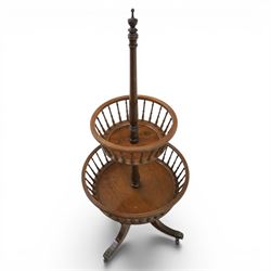 Regency style oak two-tier dumb waiter, with turned finial above central column support, two circular spindle-galleried basket tiers, raised on downswept tripod supports with brass caps and castors