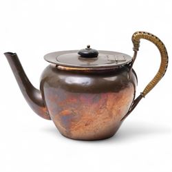 Keswick School of Industrial Arts copper teapot, stylised form with cane wrapped handle, stamped to base KSIA, H13cm 