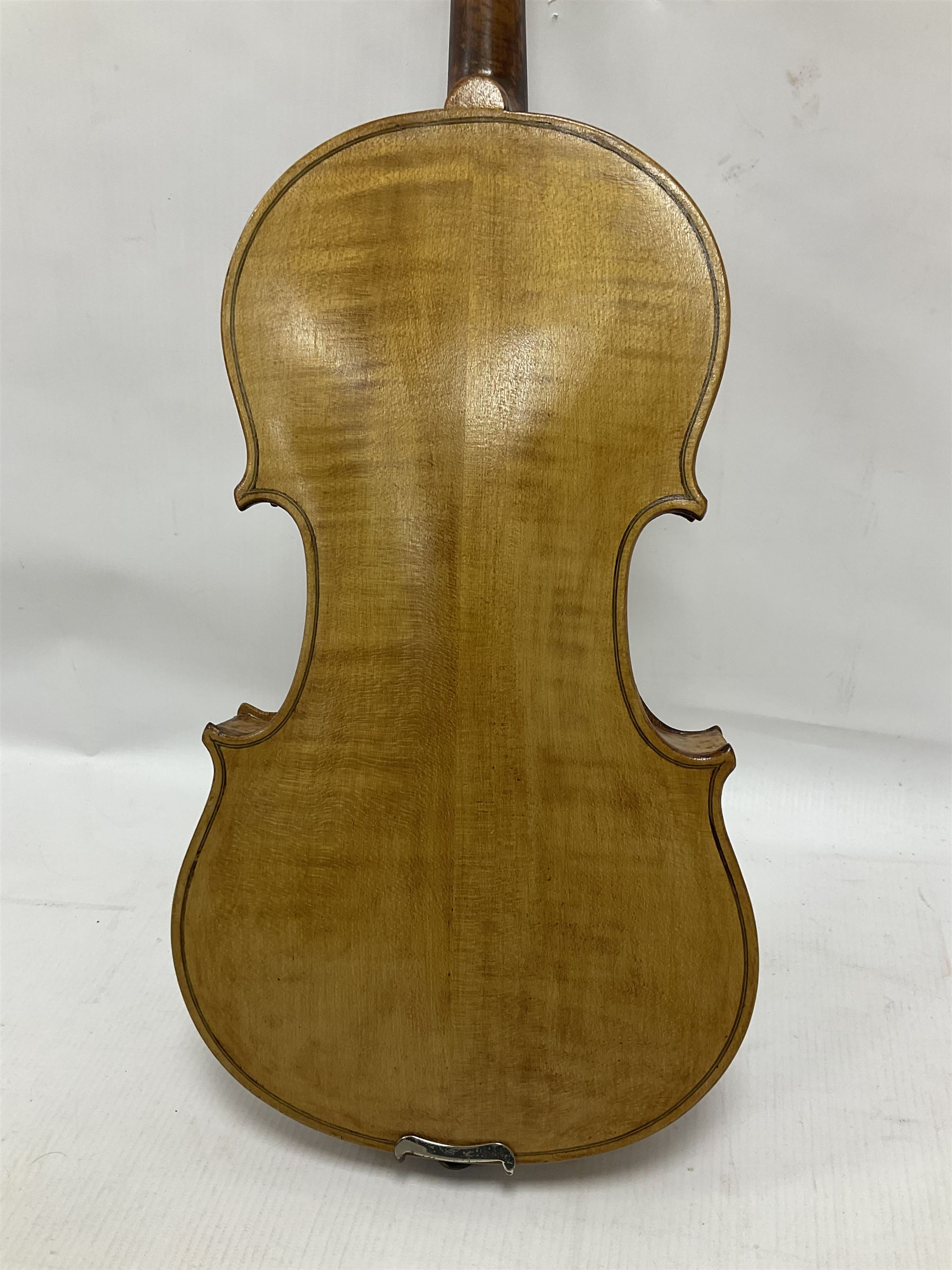 Copy of a full size Stradivarius violin, with an ebonised fretboard, tailpiece and tuning pegs, with a polished chin rest  Length 60cm
