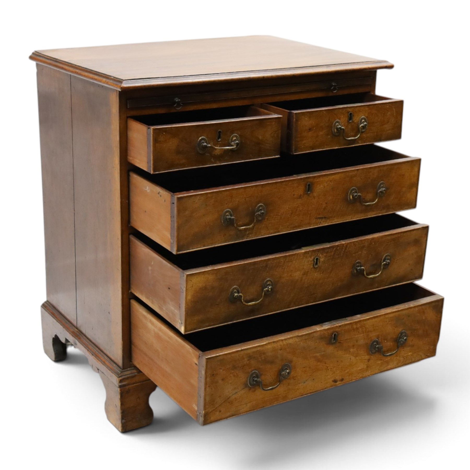 George III mahogany bachelors chest, rectangular top with moulded edge, fitted with brushing slide over two short and three long cock-beaded drawers with brass swan-neck handles, lower moulded edge on bracket feet